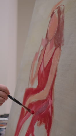 painter draws woman of dreams on canvas in studio closeup. artist uses acryl paints palette working on portrait in workshop. craftsman creates colorful artwork