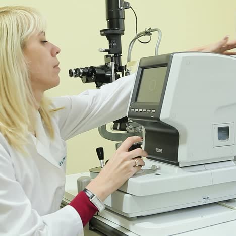 side view of female pediatric optometrist examining eyes of little boy. children ophthalmology