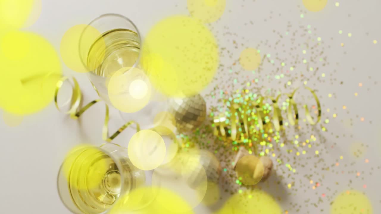 Animation of spots of light, confetti and champagne glasses