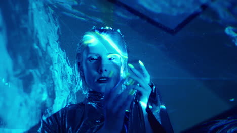 stylish alien woman posing on camera in blue laser light