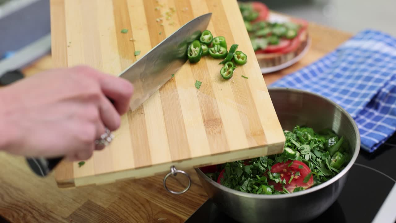 Preparing a salad with chili peppers