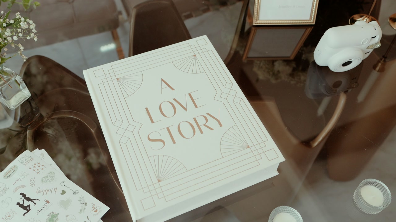 romantic wedding guest book with love story theme on table