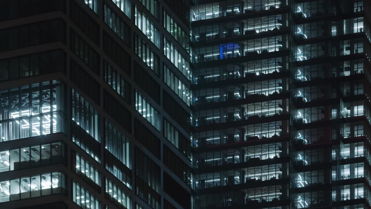 타임 라프 박이는 사무실 창문, 비즈니스 센터 건물 전면의 불빛, 늦은 밤까지 일하는 사람들, 기업 사업, 높은 마천루 유리 표면, 건물 창문의 빛이 켜지고 꺼집니다.