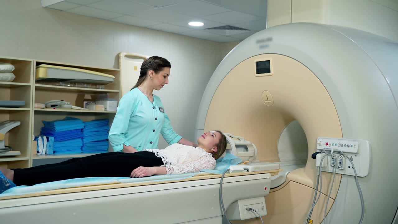 Magnetic resonance image device in hospital. Female patient lying in MRI machine and medical worker controls the procedure. Advanced medicine.