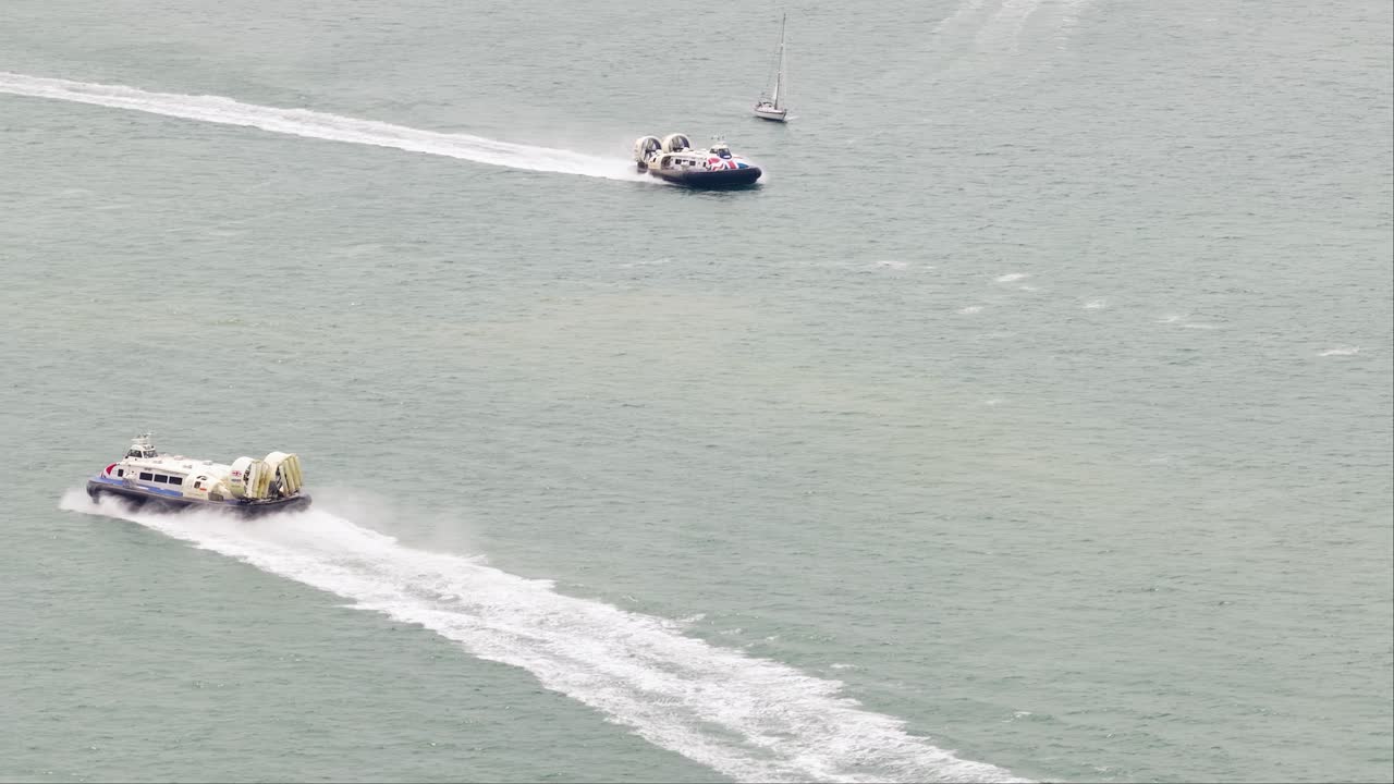 Hover crafts passing each other in open water on the Portsmouth Solent commuter service journey