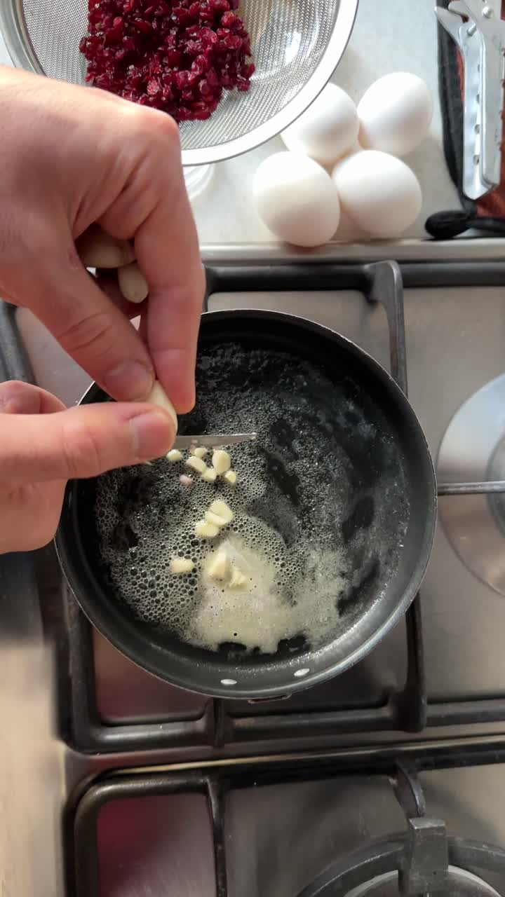 cooking tasty Omelet in butter ghee frying pan add egg to garlic in oven stove kitchen Persian breakfast pancake food lifestyle of local marinade recipe in Tehran brisket beef in traditional village