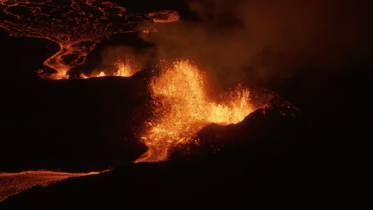 Lava bubbling out from the earths core night at a Volcano in Iceland, Aerial view