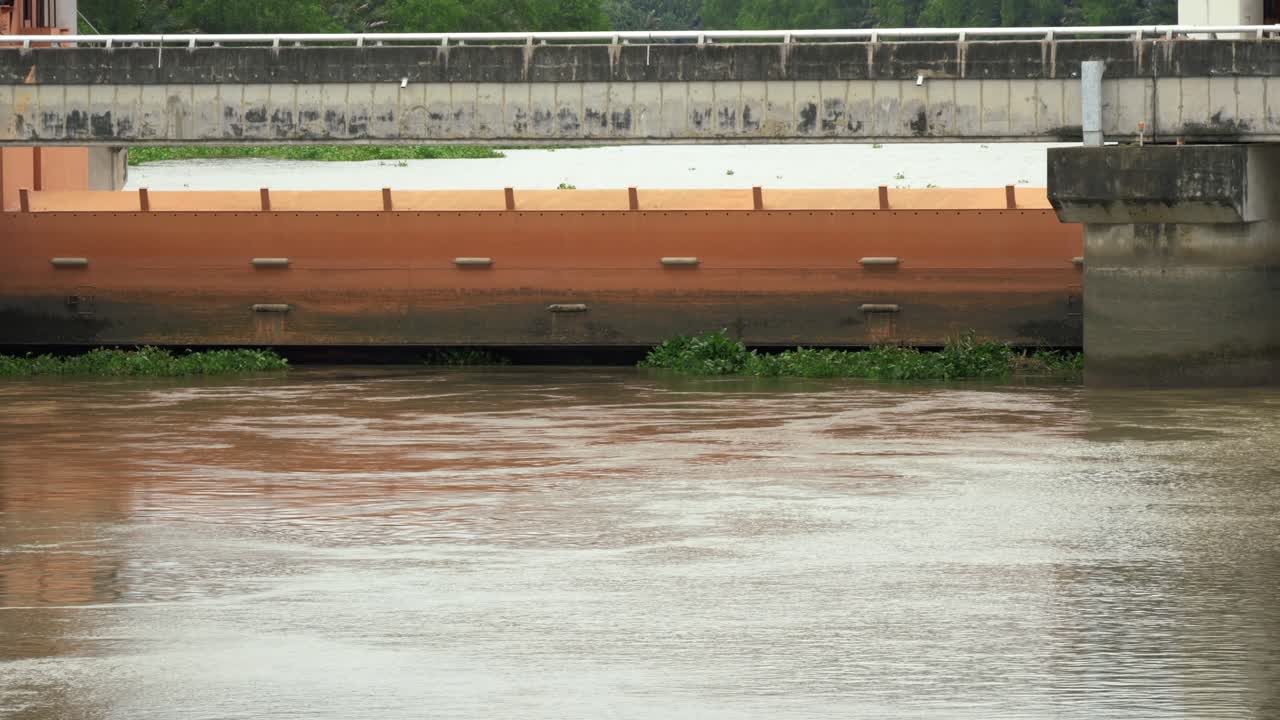 Floodwaters rise against barriers in an urban setting highlighting environmental challenges and water management concerns.