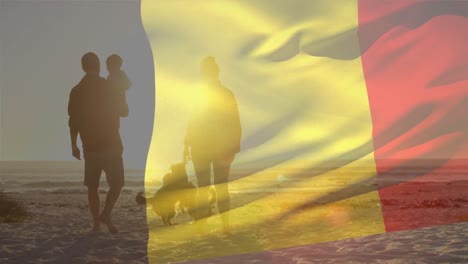 animation of flag of belgium over caucasian parents with child and dogs at beach