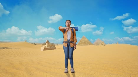 full body of asian female hiker with mountaineering backpack showing thumbs down gesture while traveling in pyramid of giza