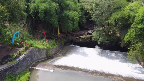 Aerial : Air Terjun Bandung, river water flowing down an old historic dam in a tropical Jungle Bali, Ubud &ndash; Indonesia