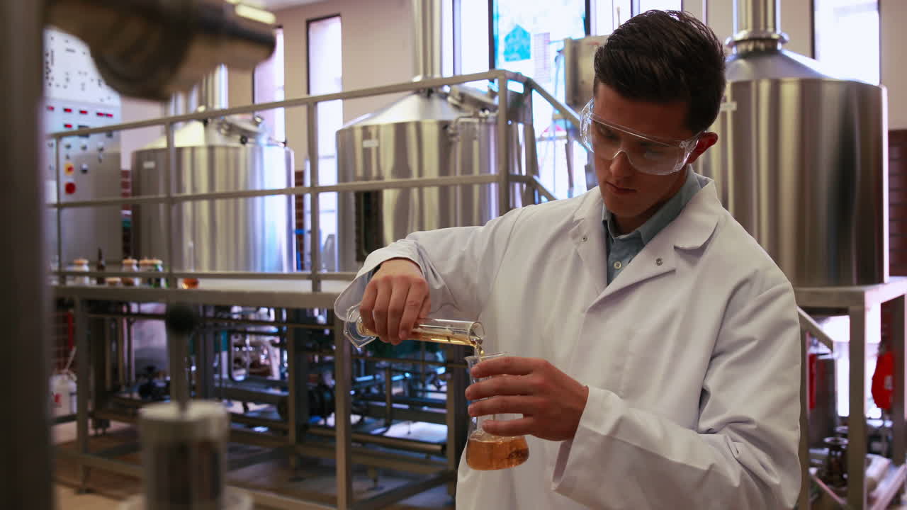 Brewery worker checking the product