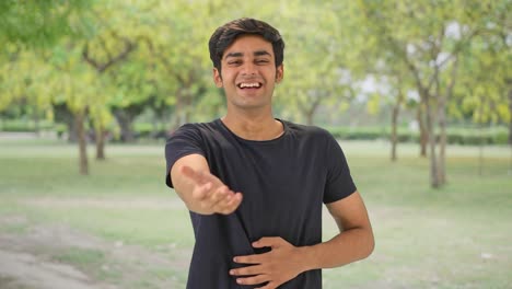 Cute-Indian-boy-laughing-on-someone-in-park