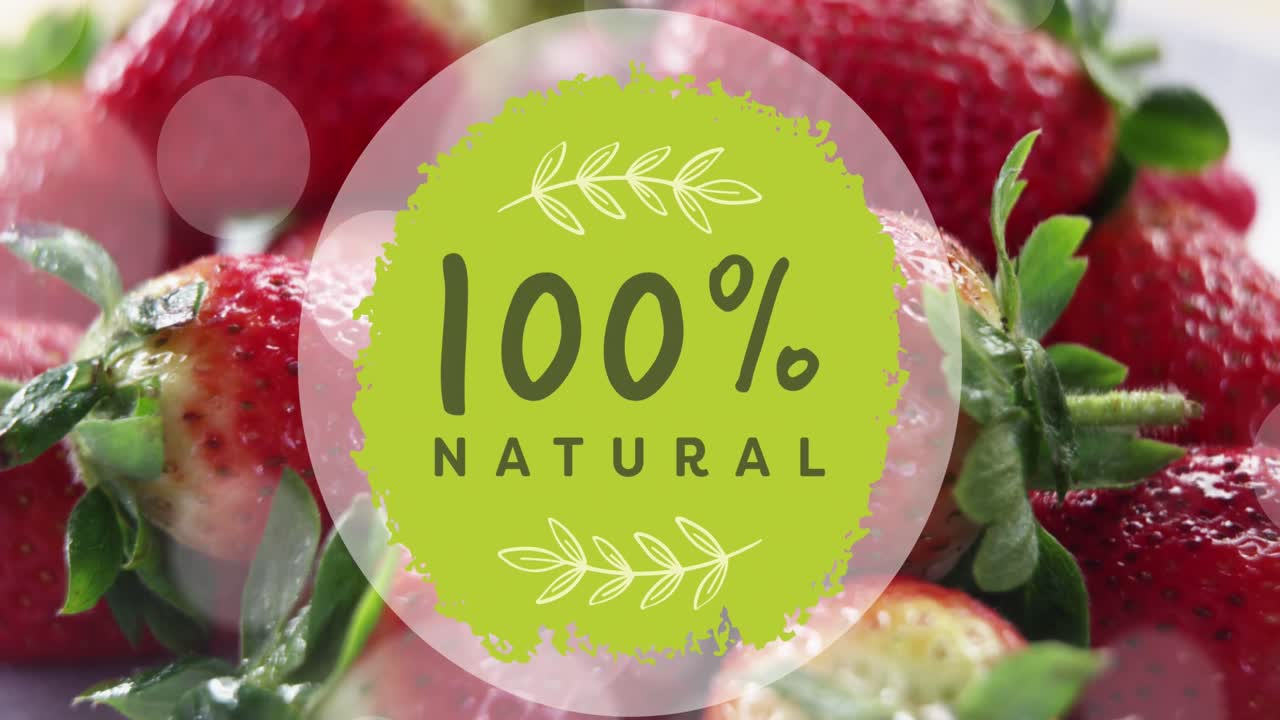 Animation of 100 percent natural text over strawberries