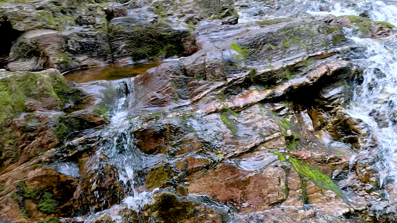 Water cascades over rocks in Dunkeld, Scotland