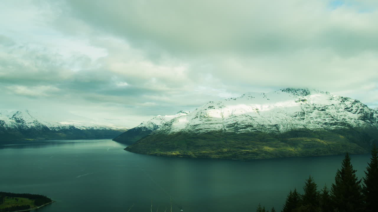 New Zealand snow capped green mountain by lake Time Lapse.