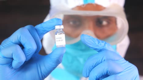 medical professional holding a covid-19 vaccine