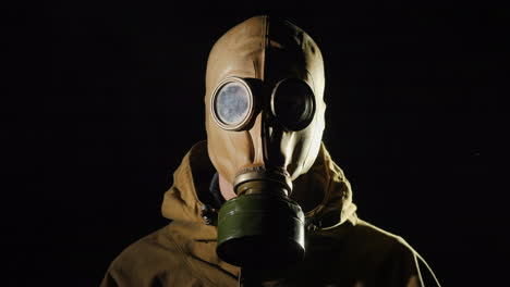 A-Man-In-A-Protective-Suit-And-Gas-Mask-Smoke-In-The-Foreground