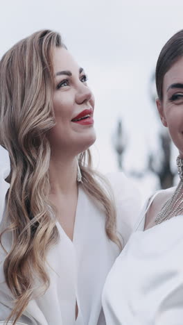 two women in white dresses