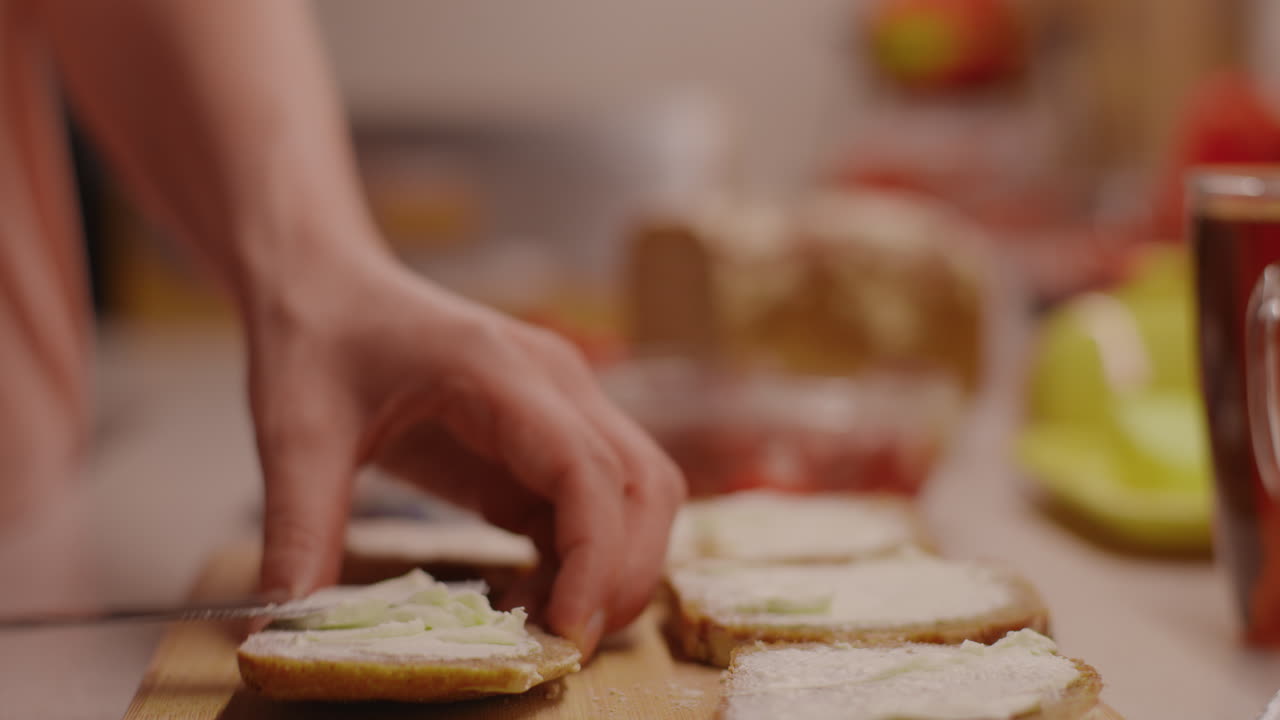 Spreading butter on bread for a sandwich