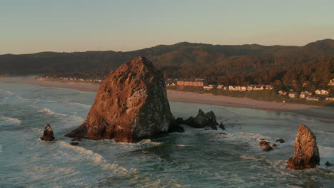 rising aerial shot of haystack rock and cannon beach