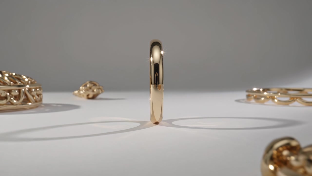 Pulling back camera revealing yellow-gold band standing on edge on white table, showcasing pendant