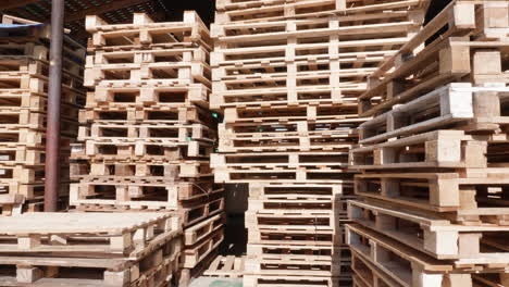 stacked wooden pallets in a warehouse yard