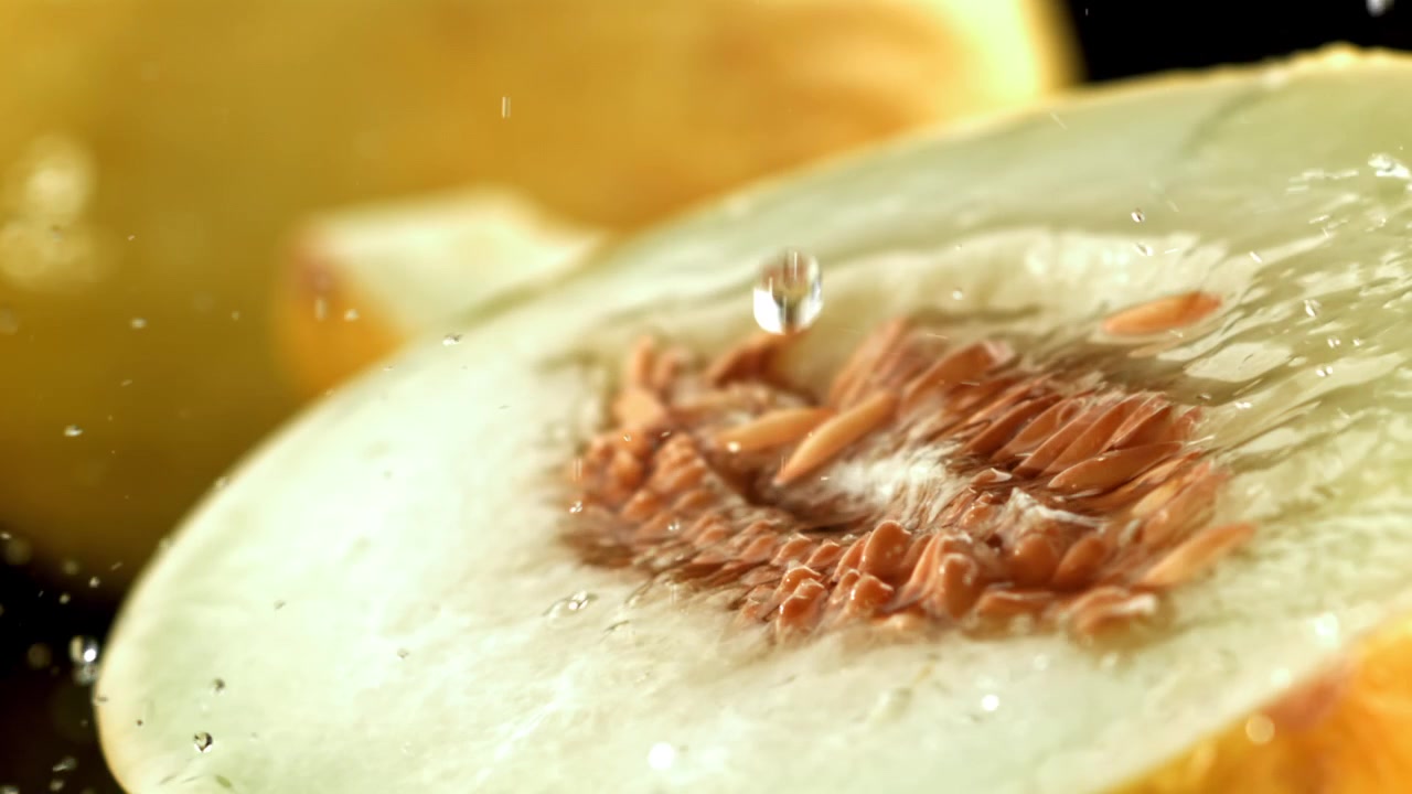 Refreshing Water Splashing on Juicy Melon Half with Seeds
