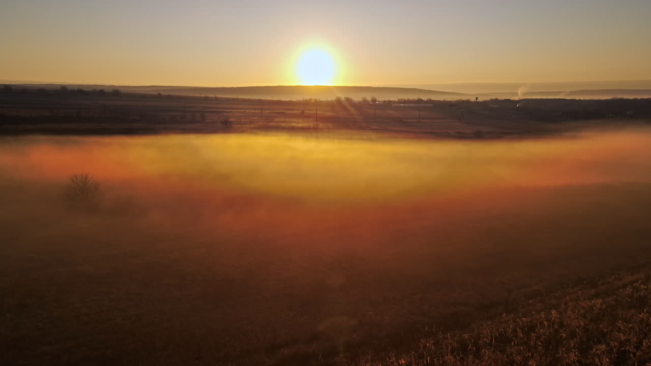 Aerial drone view of the nature of Moldova in autumn. Yellowed vegetation, sunset, fog in the air