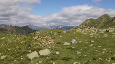 Lone-tent-standing-between-rocks-in-the-mountain-range-of-Lagorai-in-Italy