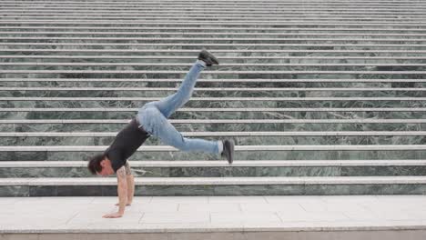 Breakdancer performing acrobatic moves on urban steps
