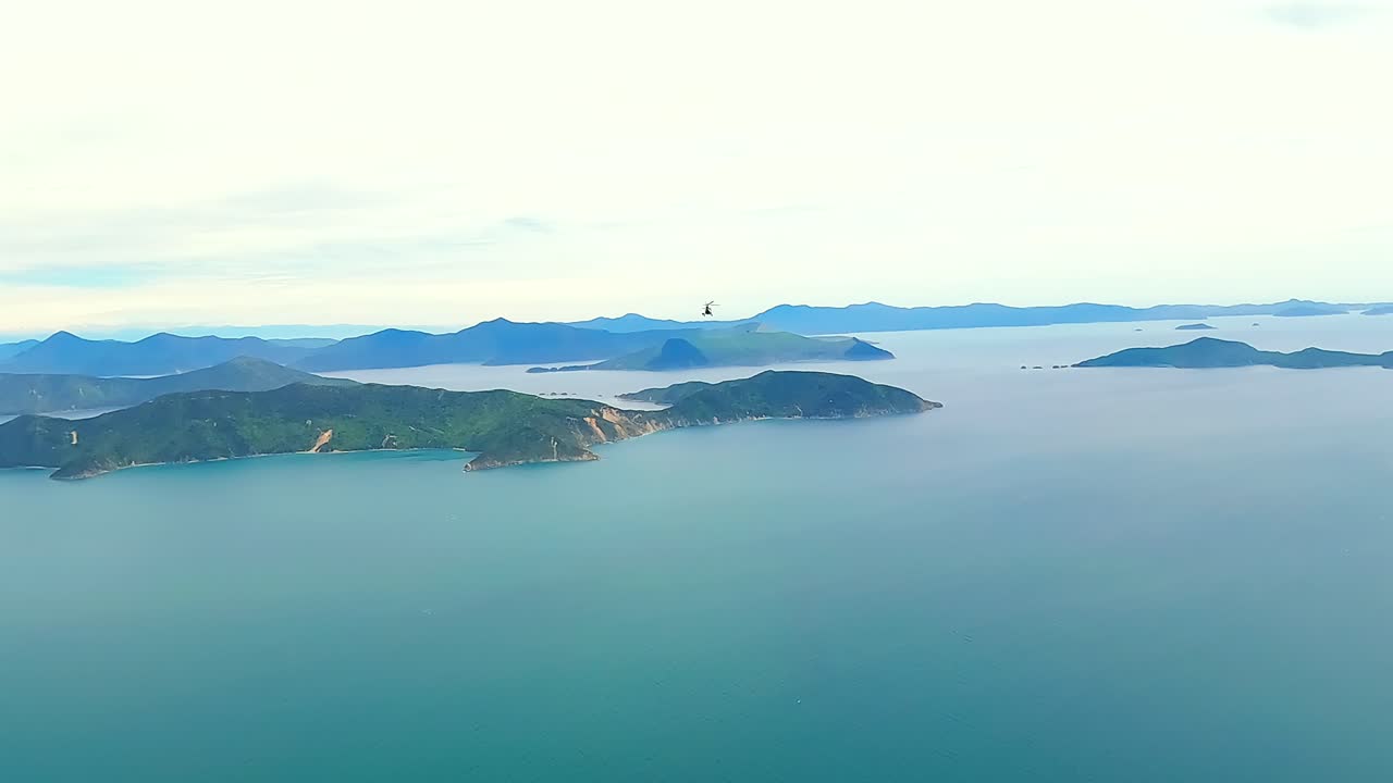 Helicopter flying high over the Marlborough sounds towards the west, New Zealand