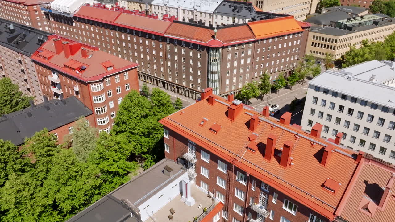 Aerial view rotating over traditional buildings in Toolo, sunny, summer day in Helsinki