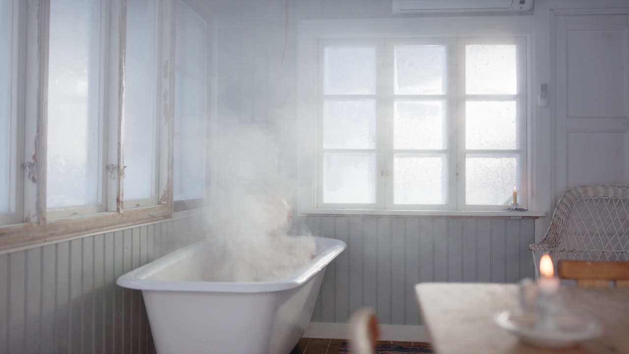 Man takes relaxing steam bath for muscle relief with burning candle on table