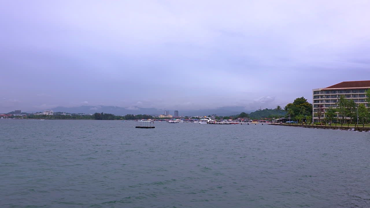 Boats And Seafront Hotels On A Cloudy Day In Kota Kinabalu, Sabah, Malaysia. - wide shot
