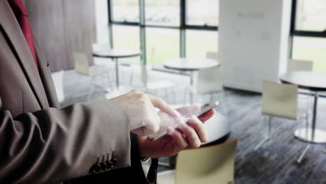 Businessman-using-smartphone-in-canteen