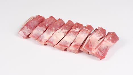 raw bacon, isolated on white. side view. loop motion. rotation 360