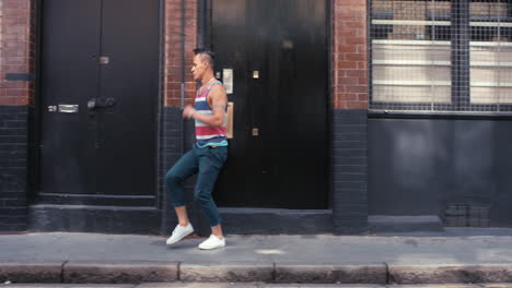 Contemporary-funky-Brazilian-man-street-dancer-dancing-freestyle-in-the-city