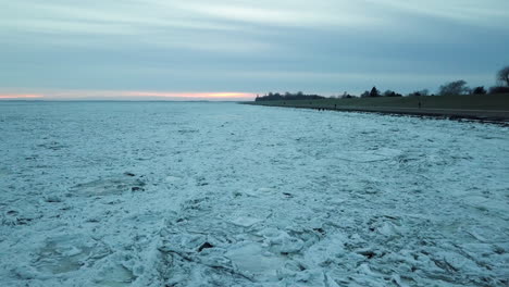 drone over snowy landscape on a cloudy sunset