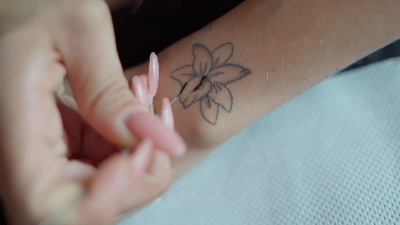 Girl doing a tattoo on herself HFR