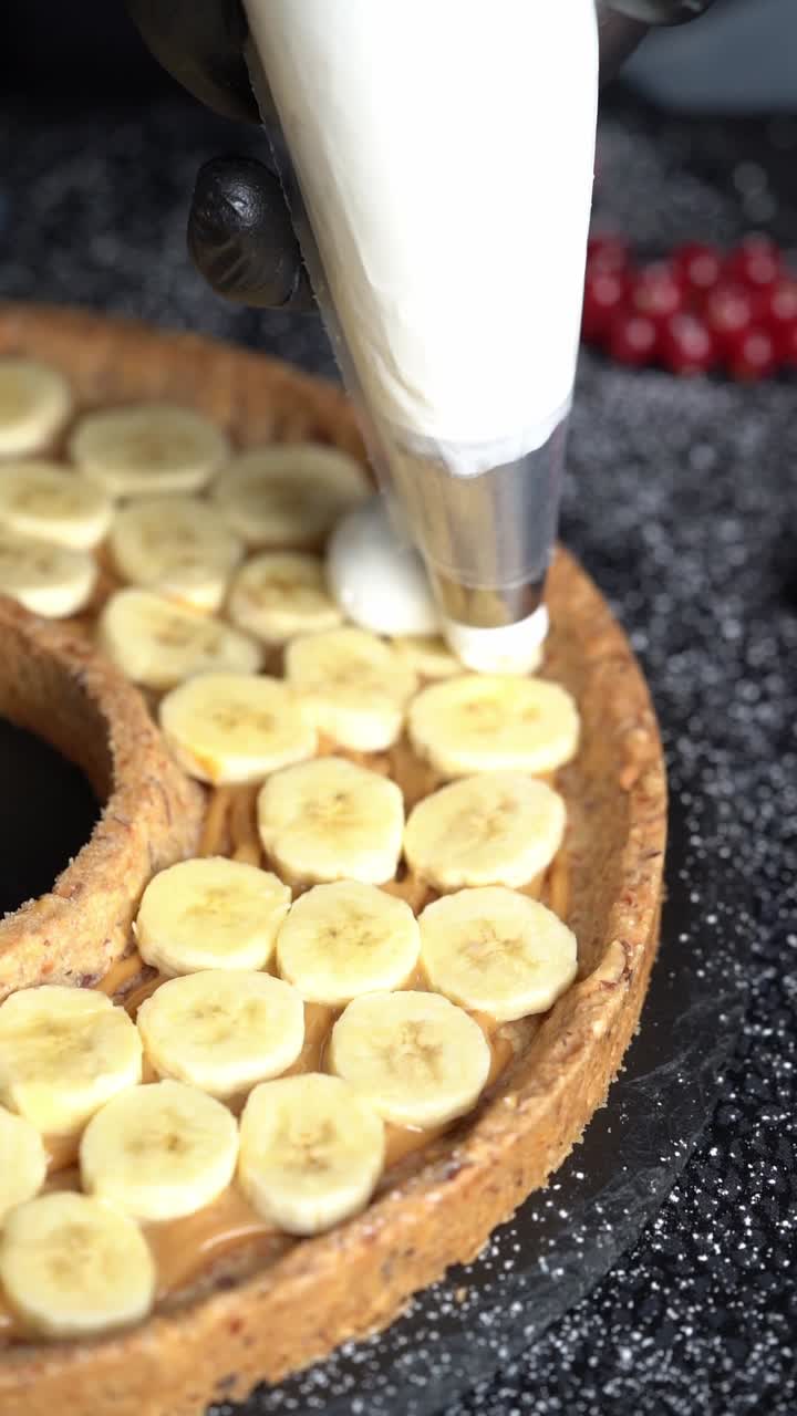A skilled chef adding smooth cream to a delicious cake, close up shot, insert shot