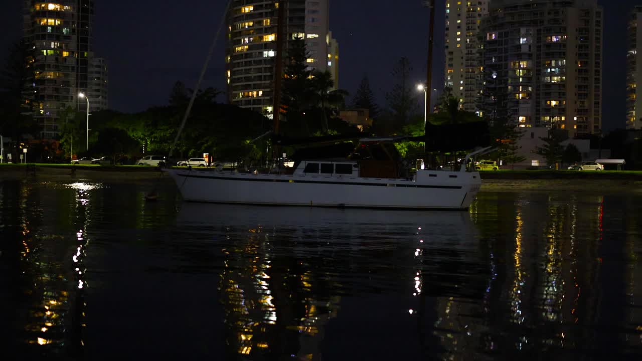 밤 에 운하 에서 항해 하는 요트