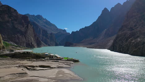 aerial view flying over scenic attabad lake, hunza valley, pakistan