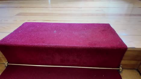 red carpeted wooden staircase