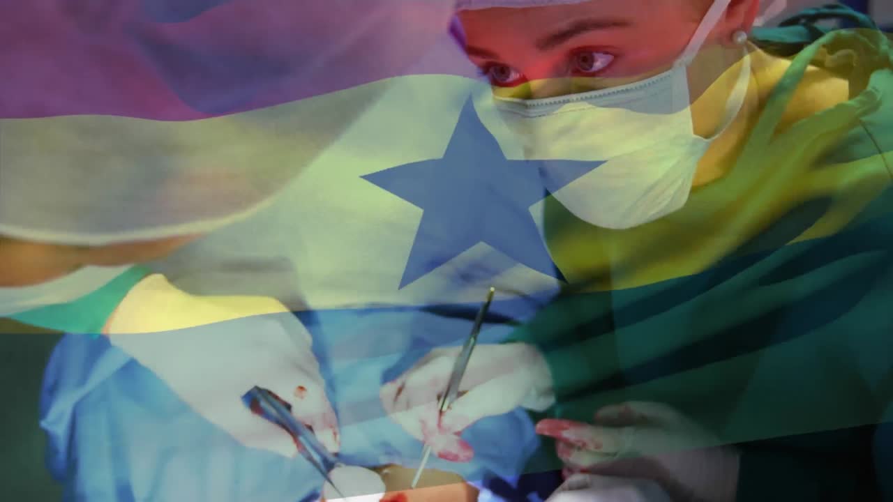 Animation of flag of ghana waving over surgeons in operating theatre