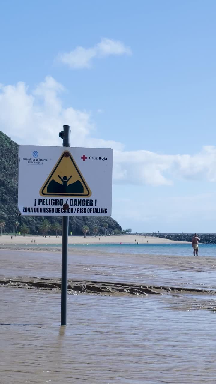 Danger Sign on Beach with Risk of Falling Warning