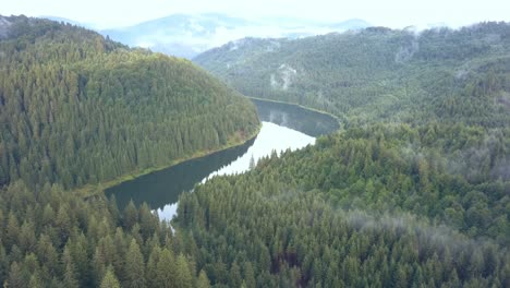 Stationary-Aerial-Drone-Shot-of-a-Picturesque-River-through-a-Romanian-Mountain-Range