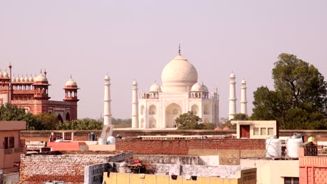 tilting down from taj mahal to houses and buildings in agra city india