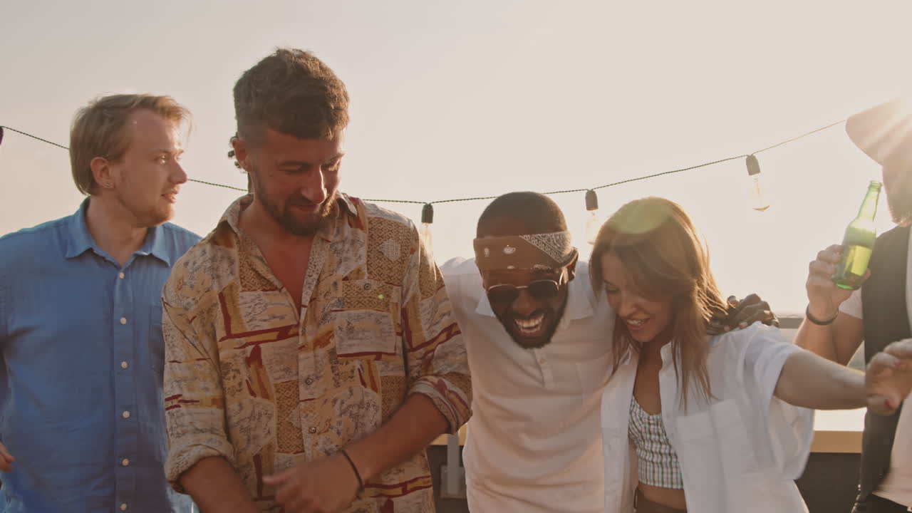 Happy People Laughing and Dancing at Rooftop Party