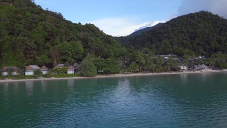 Fantastic-aerial-top-view-flight-Huts-Resort-Beach-Bungalows,-Jungle-hilly-Island-Thailand-2022